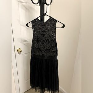 Sleeveless black dress with sparkly lace top